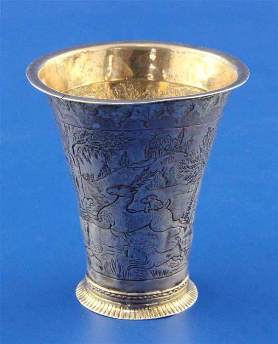 An 18th century German? parcel gilt silver beaker, 48 grams.